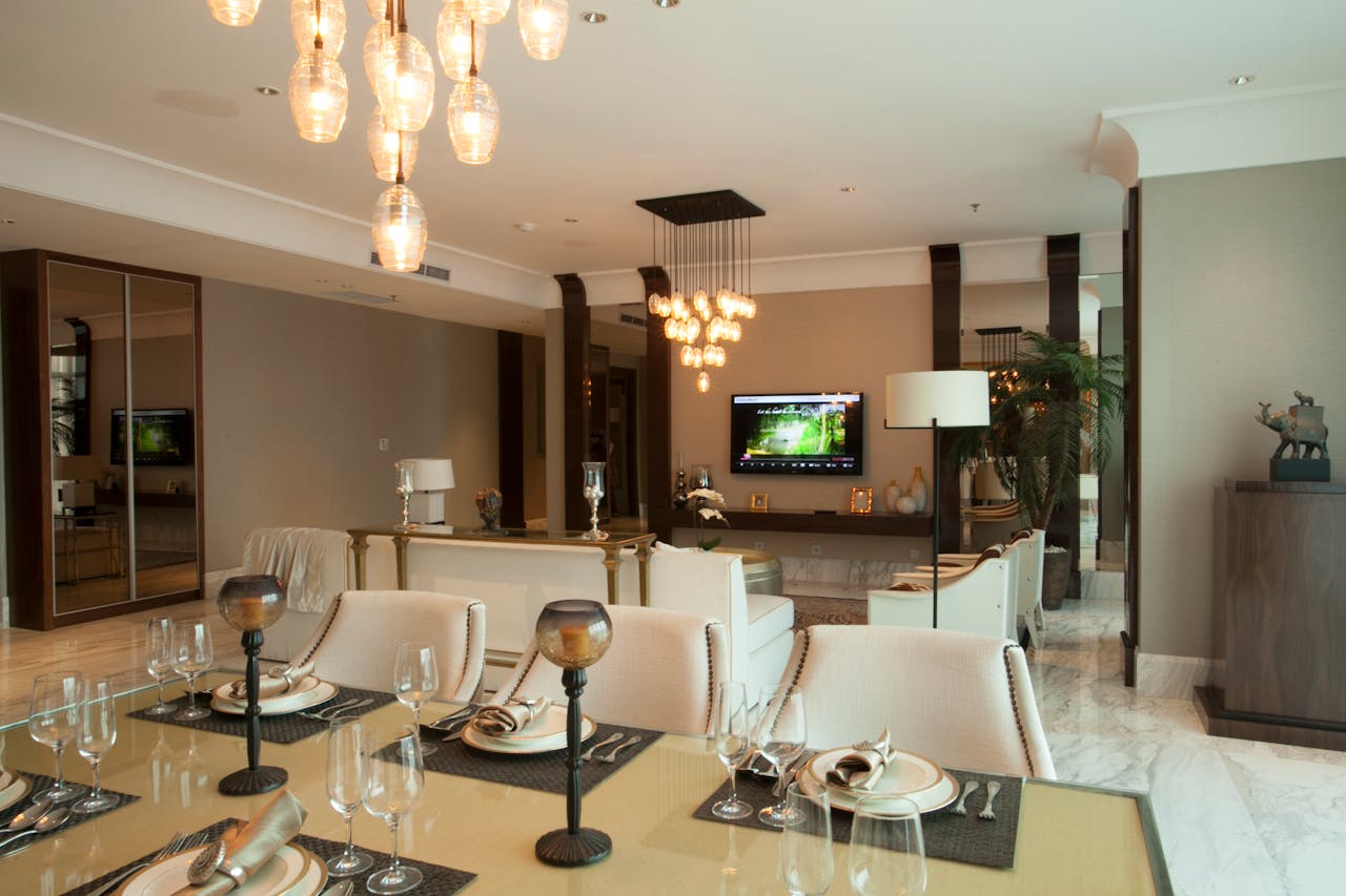 Luxurious dining and living room with modern decor and ambient lighting.