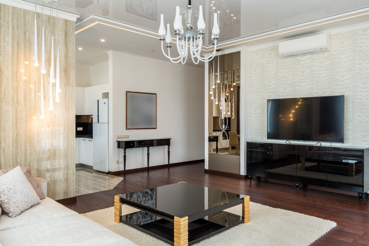 Elegant modern living room featuring a chic chandelier and contemporary decor.